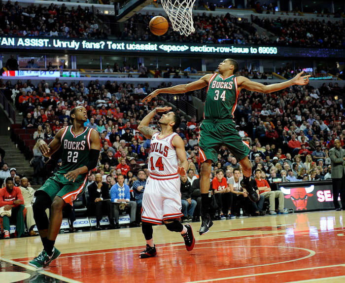Apr 4, 2014; Chicago, IL, USA; Chicago Bulls guard D.J. Augustin (14) Milwaukee Bucks guard Giannis Antetokounmpo (34) andforward Khris Middleton (22) go for a loose ball during the second half at the United Center.